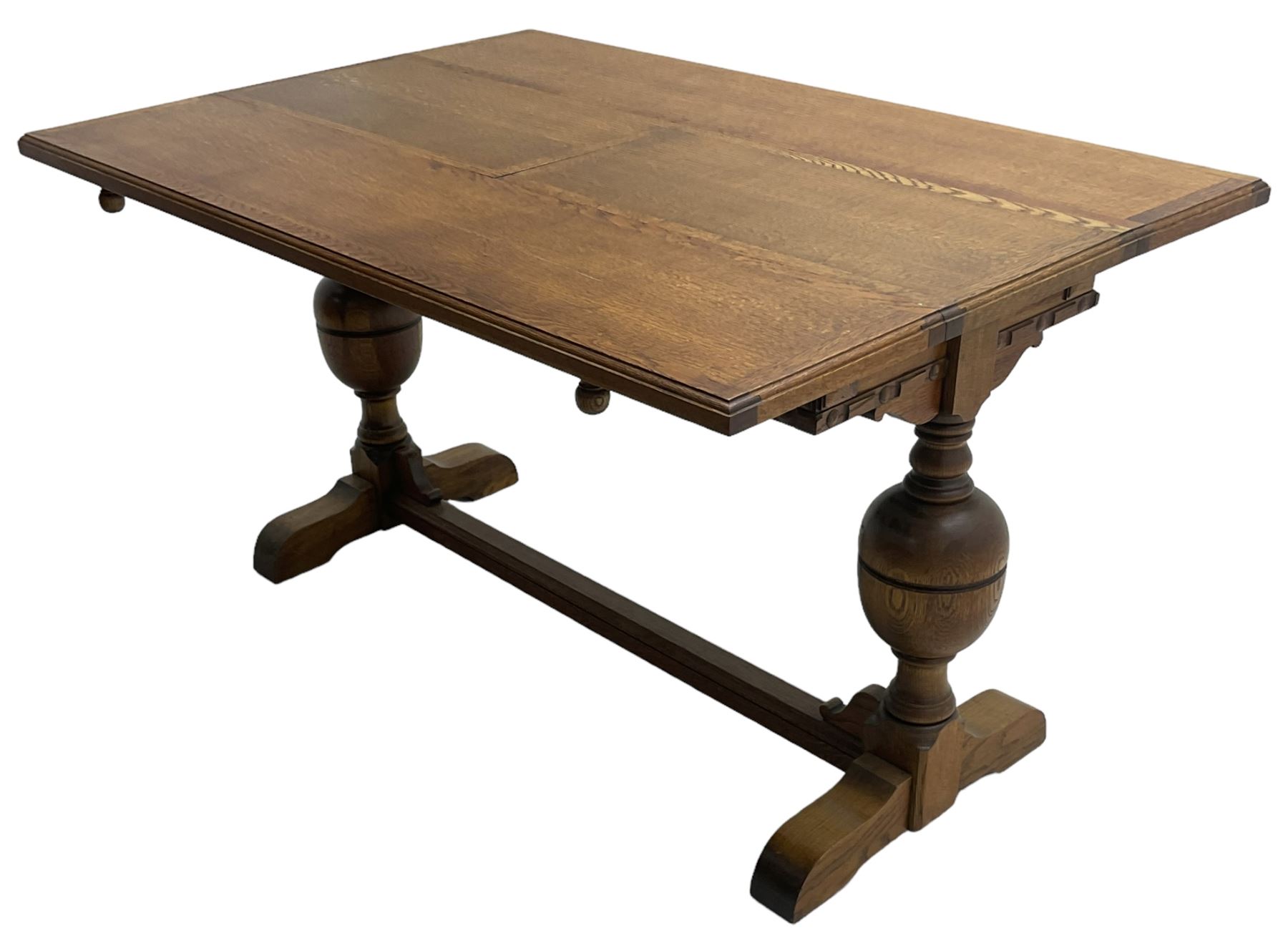 Early 20th century oak 'Ee-zi-Way one motion extending dining table', rectangular top over twin baluster end supports united by stretcher