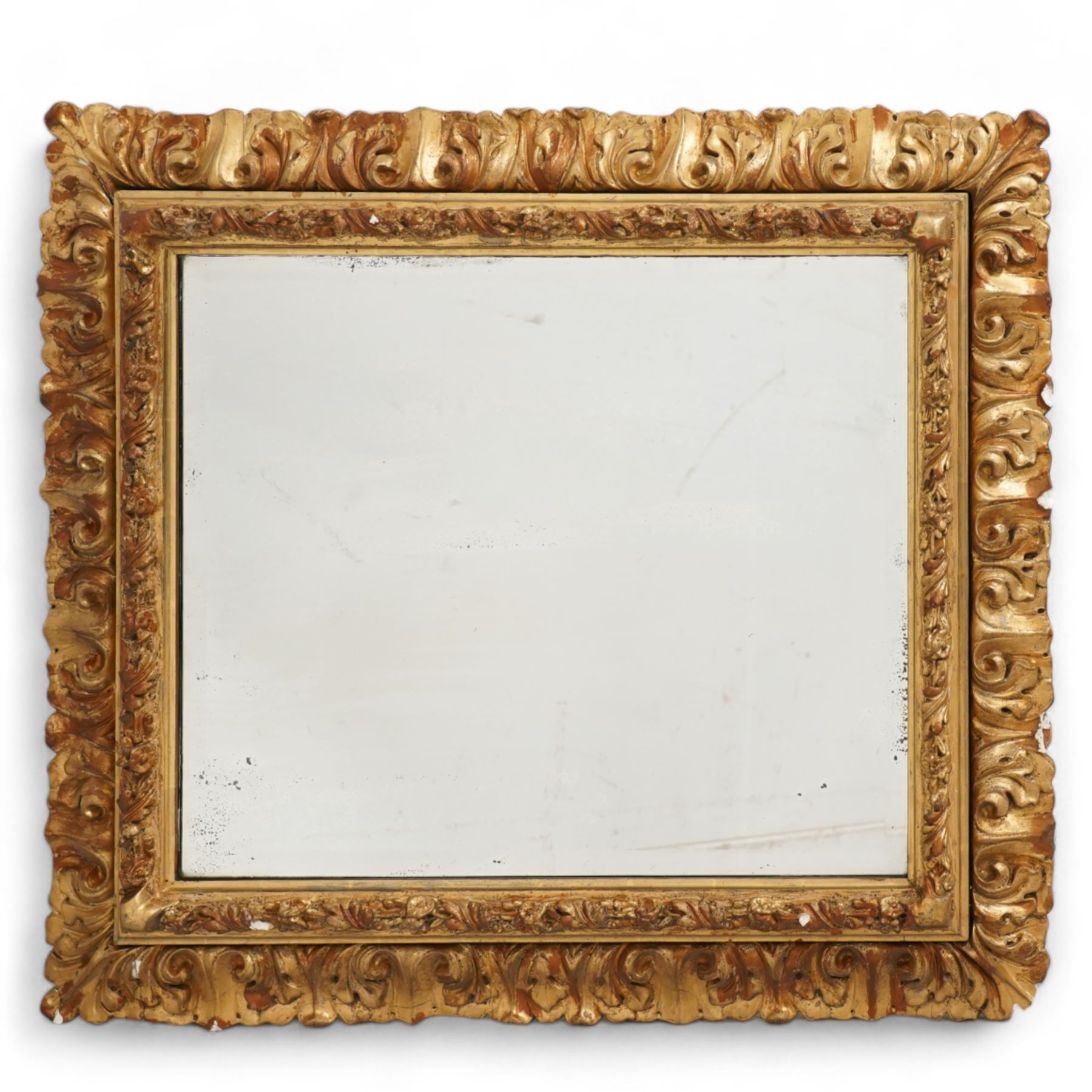 19th century gilt and gesso framed wall mirror, the rectangular beveled plate within an acanthus ribbon-twist moulded inner frame with moulded rose motifs, the outer frame decorated with moulded curling acanthus leaves