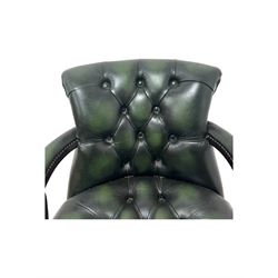 Victorian design Captains swivel desk chair, rolled tub shaped back with open arms, upholstered in deep buttoned green leather with studwork border