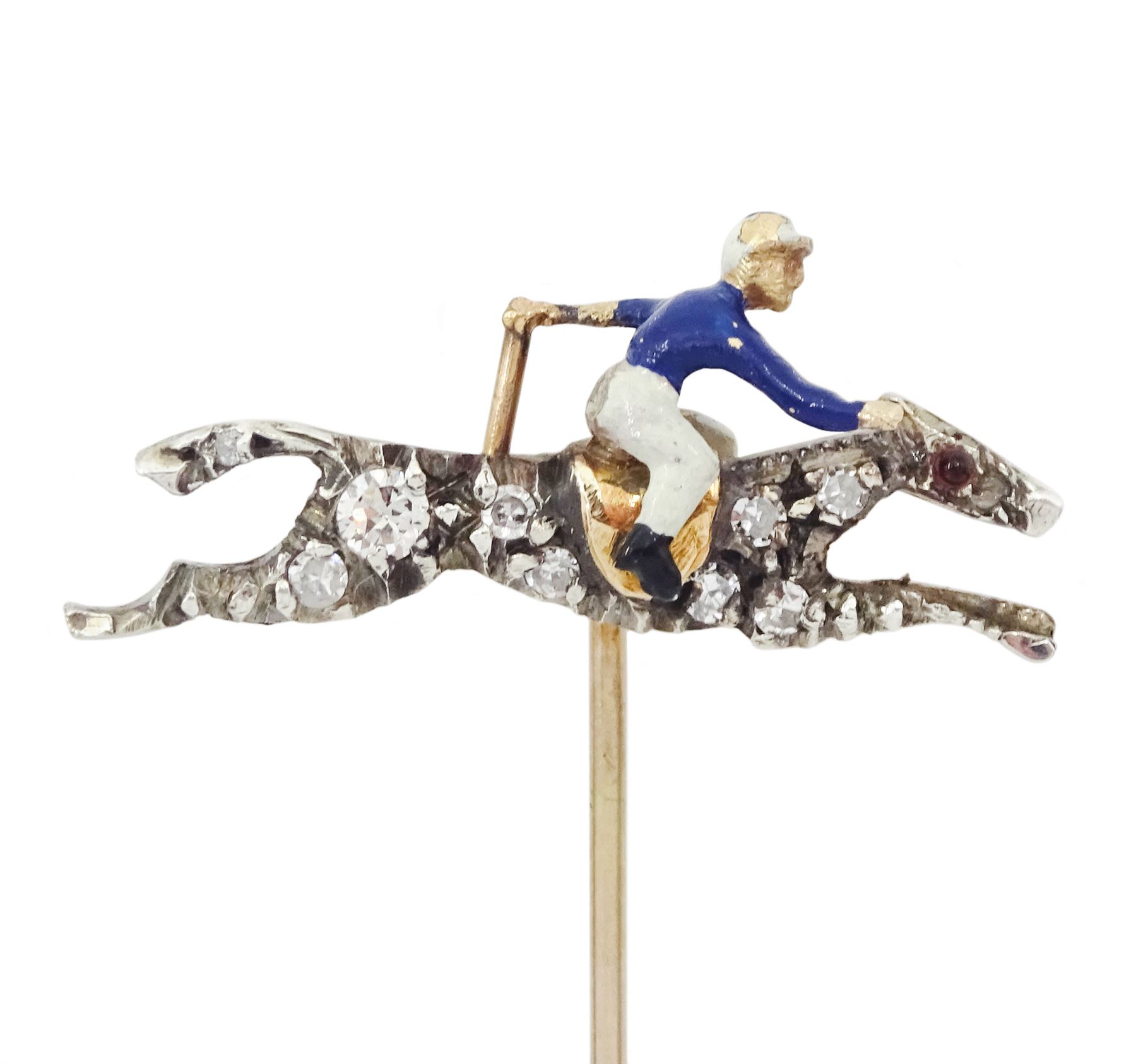 Early 20th century gold and silver, diamond and enamel stick pin, the galloping horse set with single cut diamonds, the jockey with blue and white enamel, in velvet and silk lined box