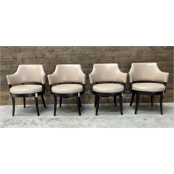 Four ebonised framed tub shaped armchairs, upholstered in beige fabric