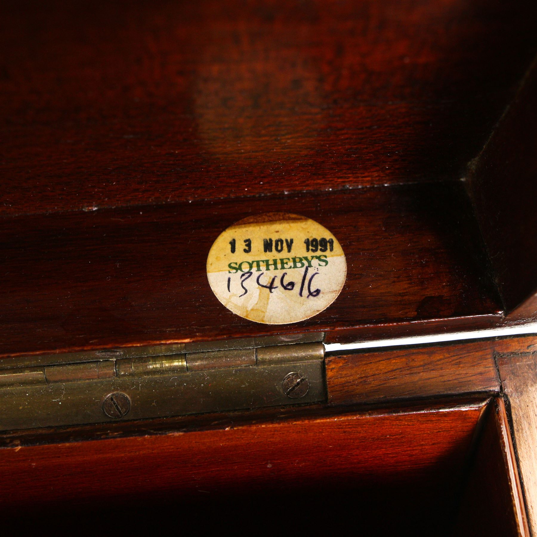 19th century Mahogany stationery box inlaid with boxwood stringing, the hinged sloping lid inset with a brass plaque engraved with initial 'R', divided interior with Sothebys lot label 'November 1991' W39cm