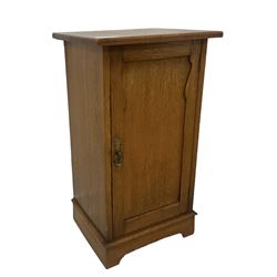 Arts and Crafts period oak pot cupboard, shaped panelled door enclosing single shelf