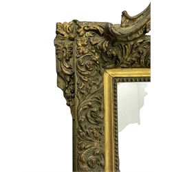 Victorian giltwood and gesso wall mirror, pierced shell cartouche pediment decorated with C-scrolls and curled leaves, moulded frame with curled acanthus leaf decoration and beaded inner slip, the corner brackets decorated with flower heads 