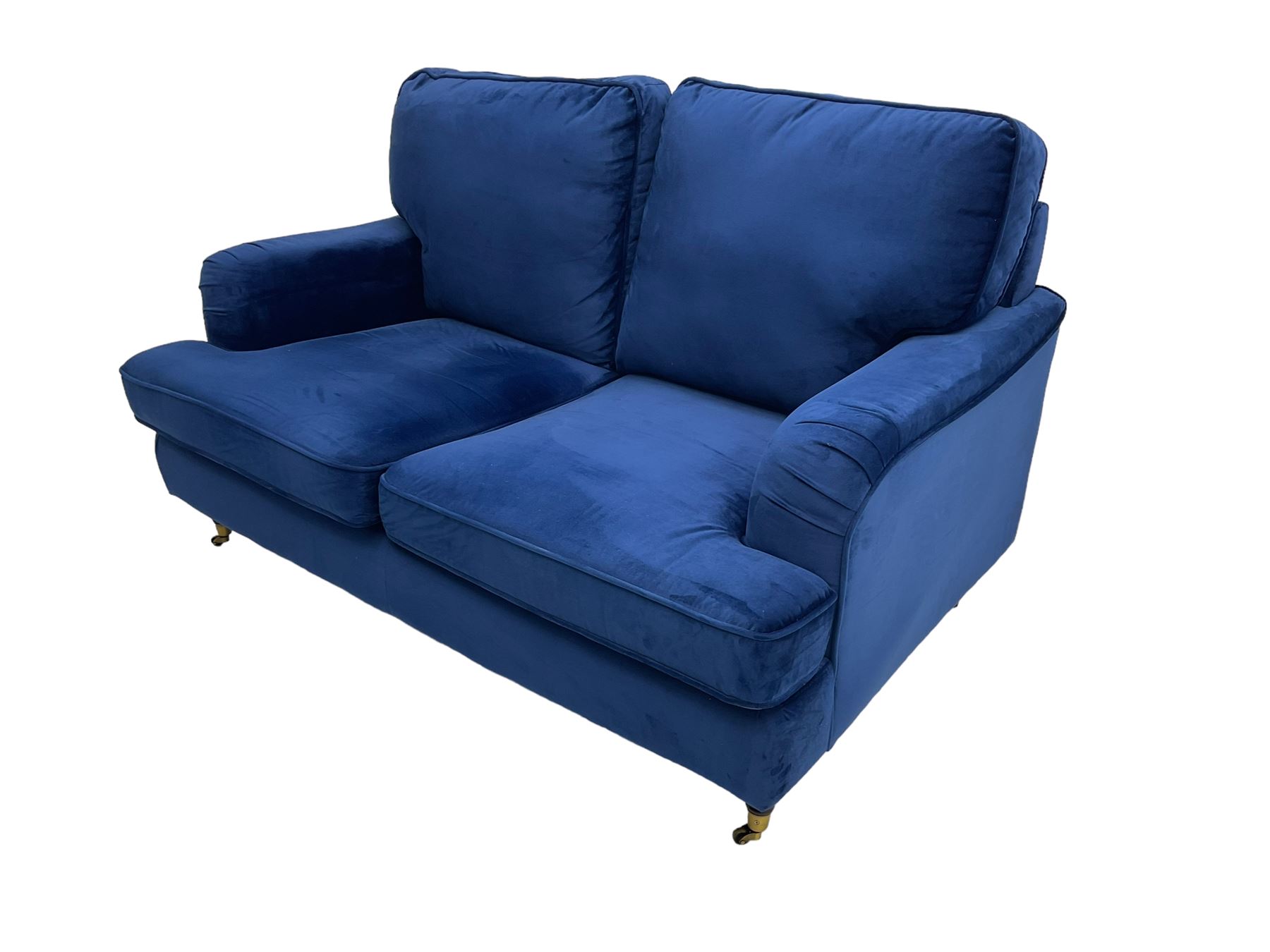 Howard design - two-seat sofa upholstered in blue fabric, traditional shape with rolled arms, on walnut finish turned feet with brushed metal cups and castors