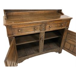 Georgian design oak dresser, two-tier plate rack with shaped aprons, the base fitted with two fielded moulded drawers, over two panelled cupboards carved with scrolling acanthus leaves, with guilloche carved central upright, on stile feet