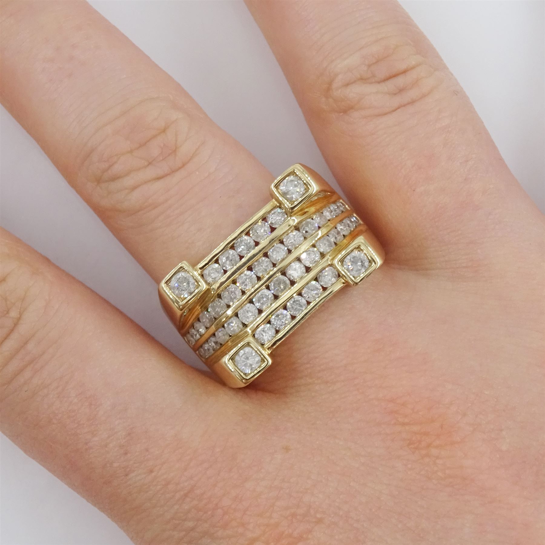 Gold channel set round brilliant cut diamond ring, with four diamonds set at each corner, hallmarked 9ct, total diamond weight 1.59 carat