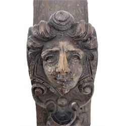 Pair of Victorian figural carved oak corbels, modelled as male and female masks, with scroll and fruit details, H22cm x W8.5cm 