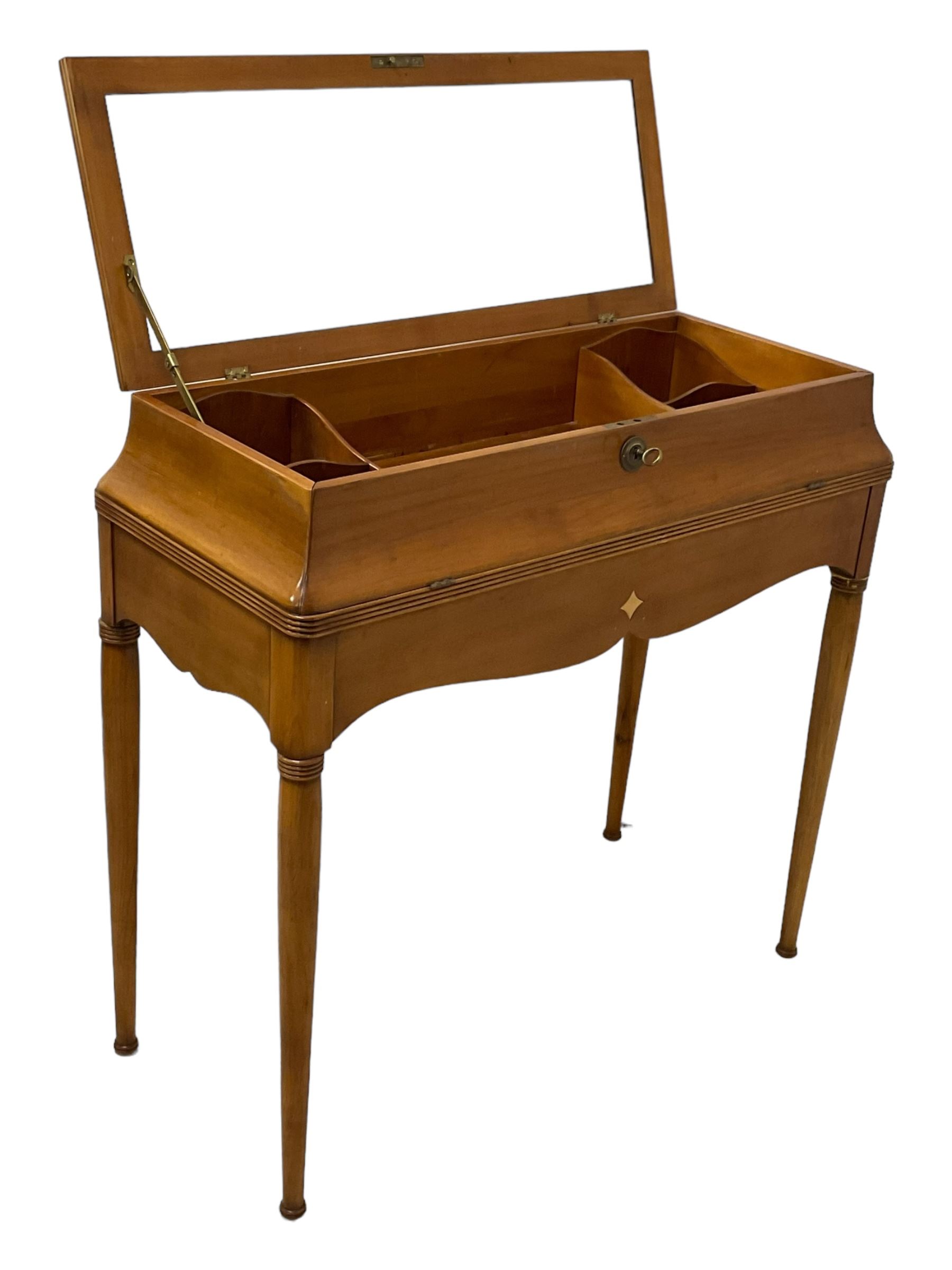 French design cherry wood dressing table, reed moulded hinged lid reveals mirror back, central compartment with lid and divisions, on turned supports