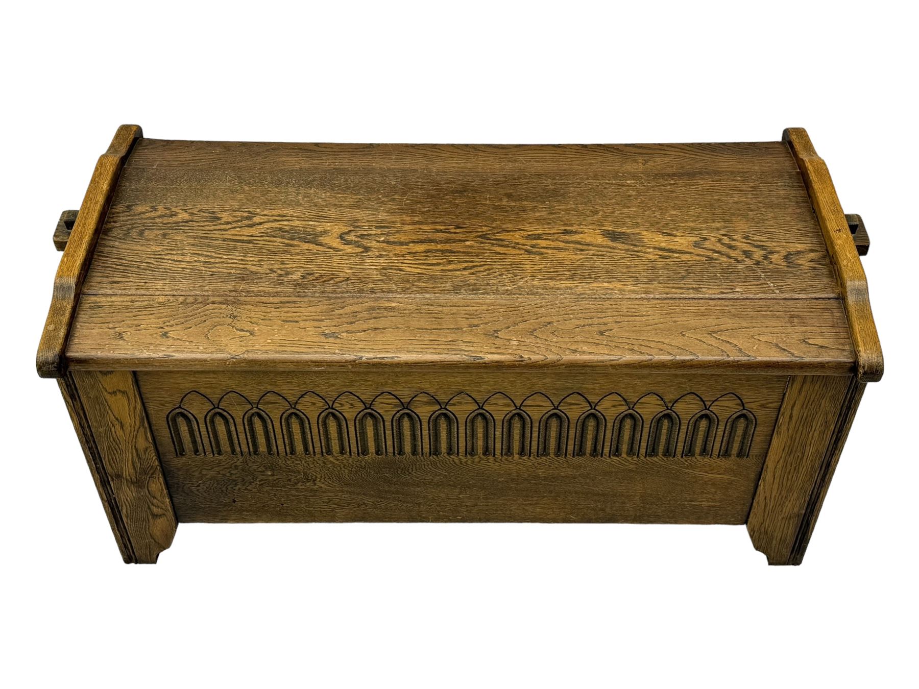 20th century oak coffer or blanket chest, rectangular hinged top over repeating Gothic arch carved front and shaped sides, constructed with pegged joints, on stile supports