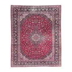 Large Persian Kashan crimson ground carpet, central floral medallion surrounded by swirlin...