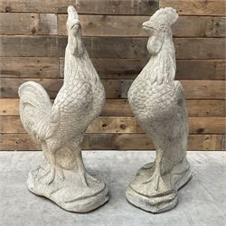 Pair of cast stone garden cockerell figures, mounted on shaped base