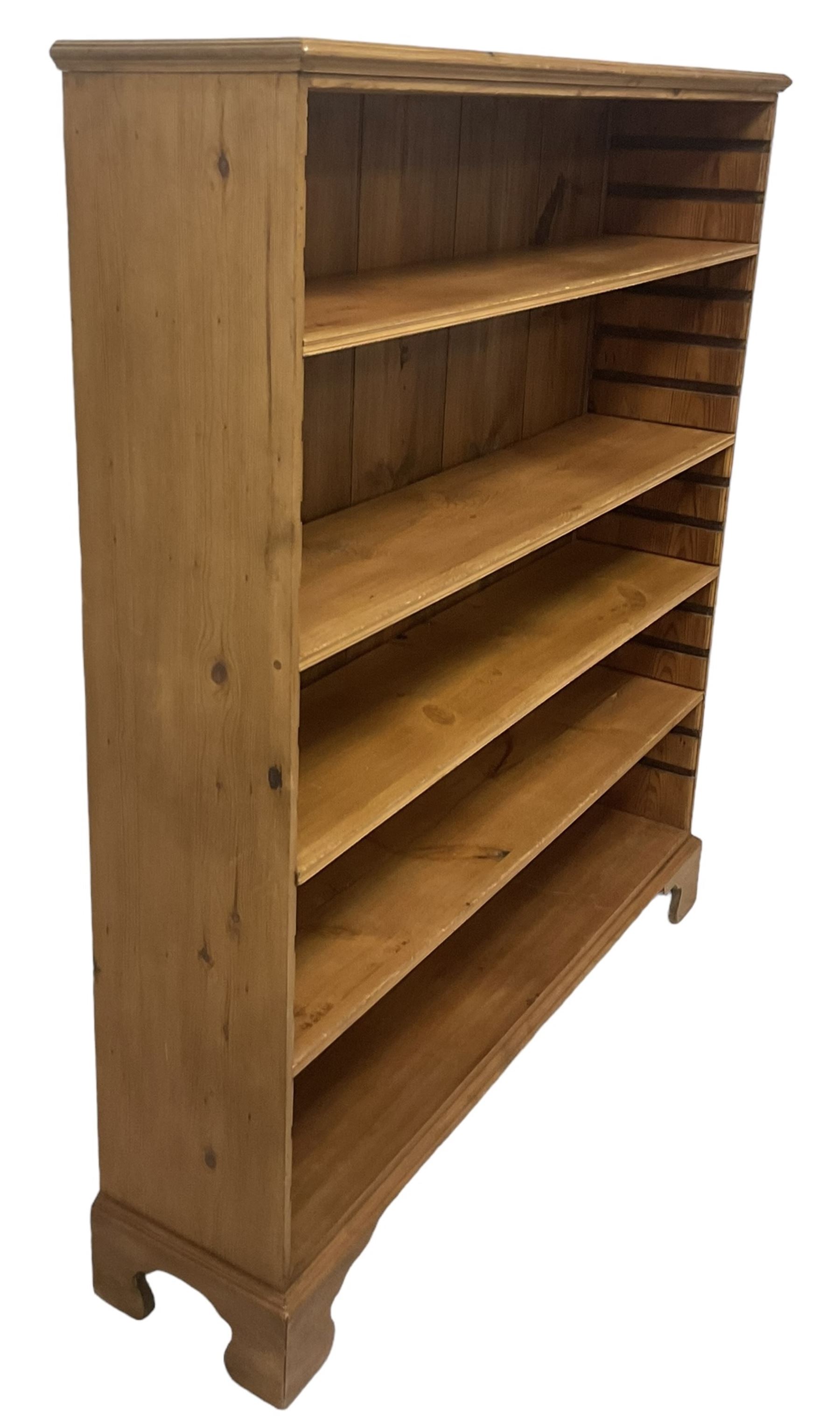 Georgian and later pine open bookcase, fitted with three adjustable shelves, on bracket feet