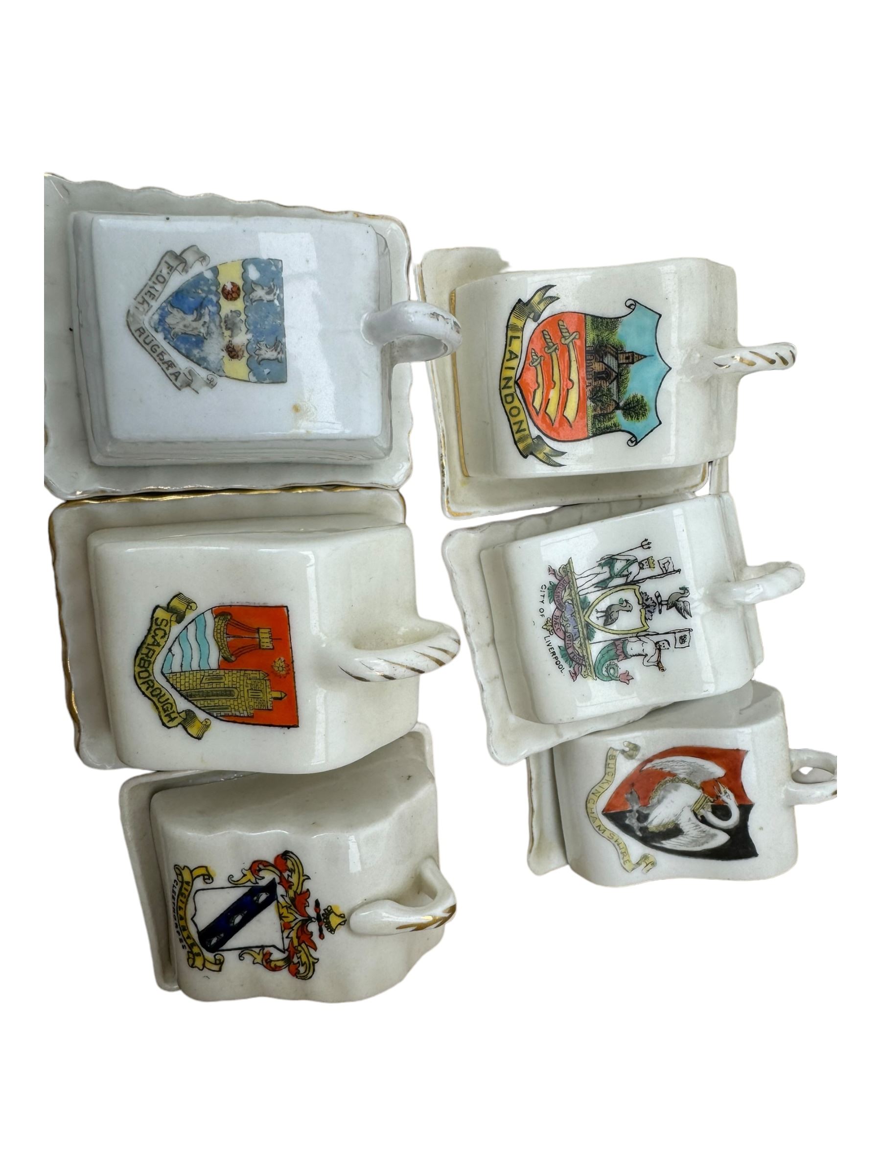 Collection of crested ware miniature cheese dishes and covers, including one by Goss, in one box