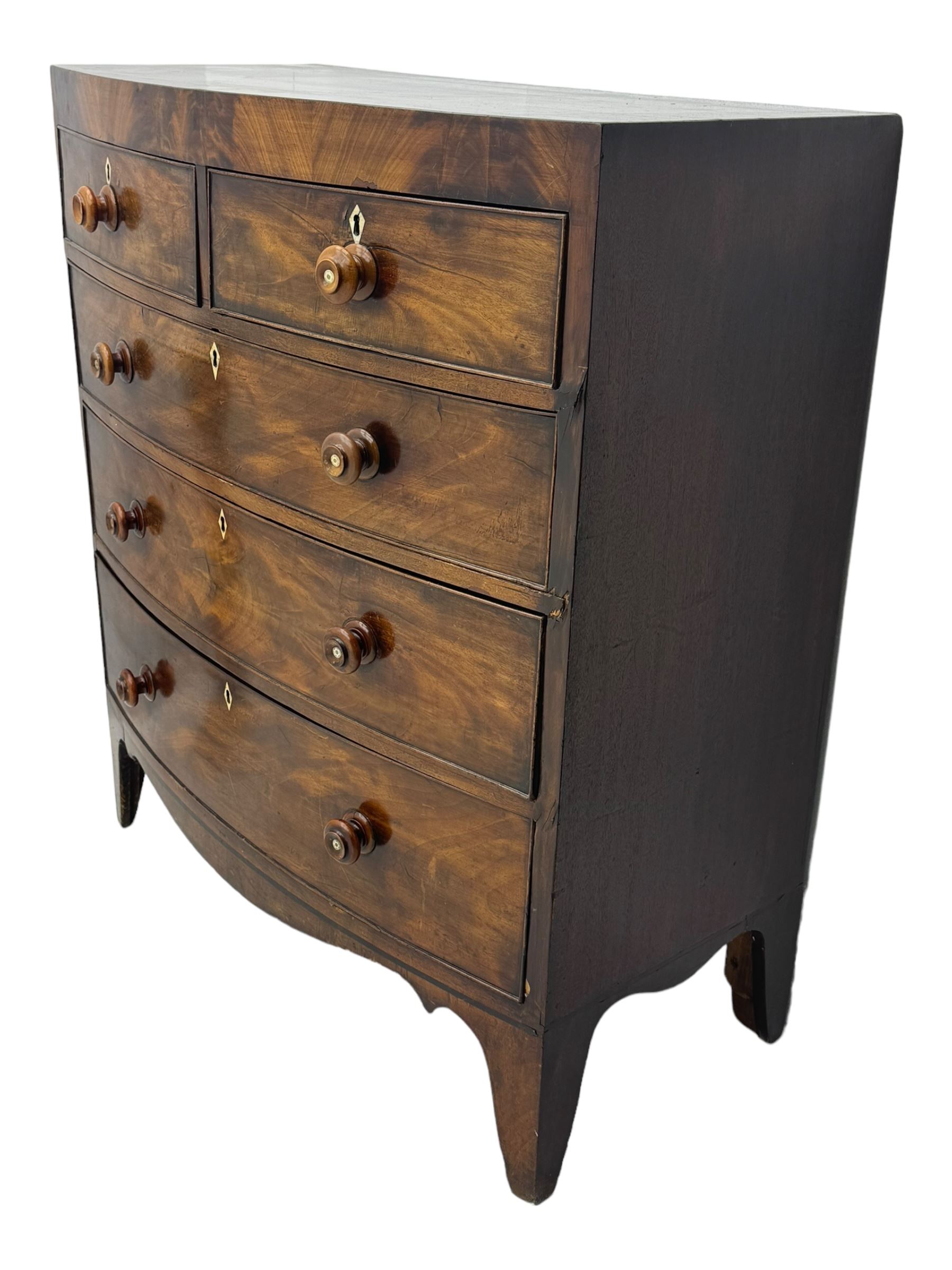 Early 19th century mahogany bow-front chest, fitted with two short over three long graduated cockbeaded drawers, each with turned wooden knobs and bone escutcheon, raised on splayed bracket supports