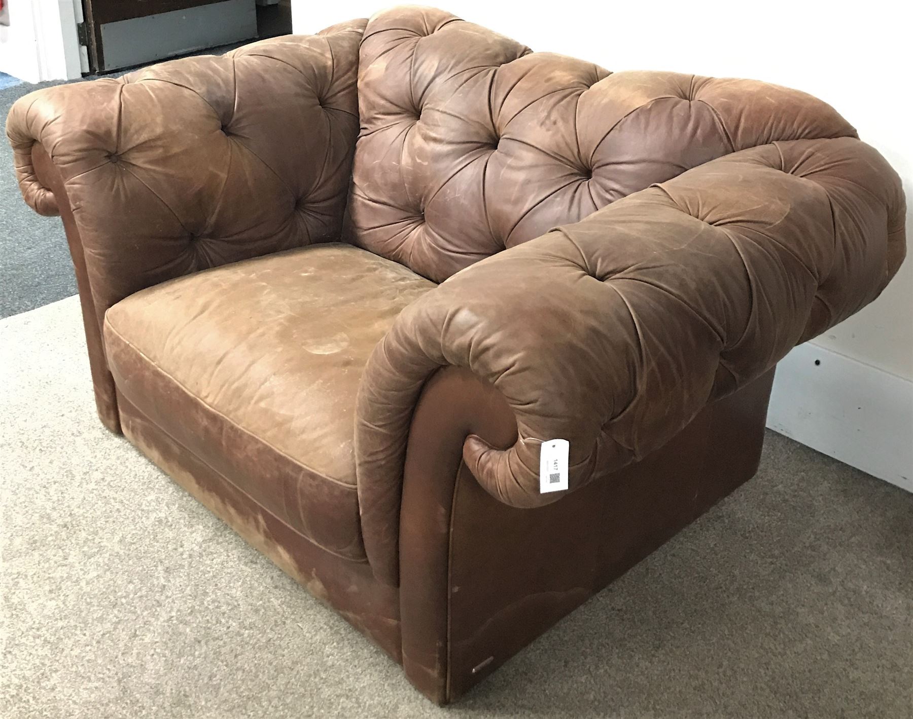 Snuggle armchair upholstered in a deep buttoned chocolate fabric