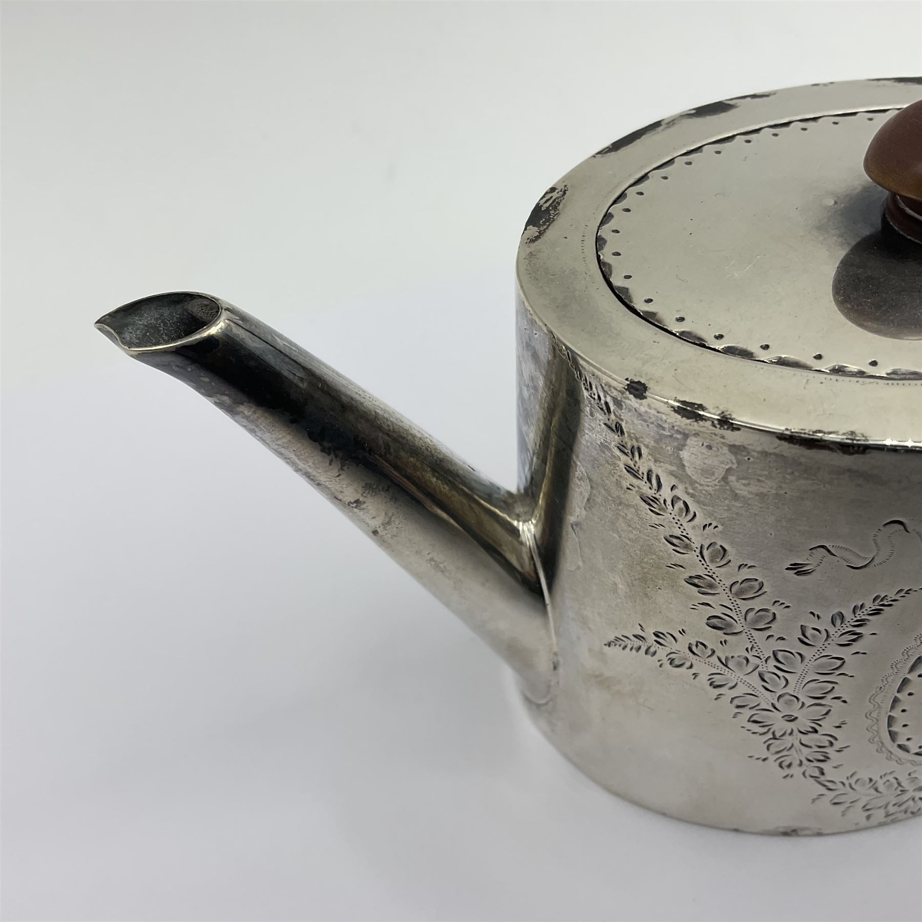 George III silver bachelors teapot, of oval form with wooden scroll handle and finial, the body chased with armorial crest and ribbon swag and foliate detail, hallmarked Samuel Godbehere & Edward Wigan, London 1793, including handle H9cm