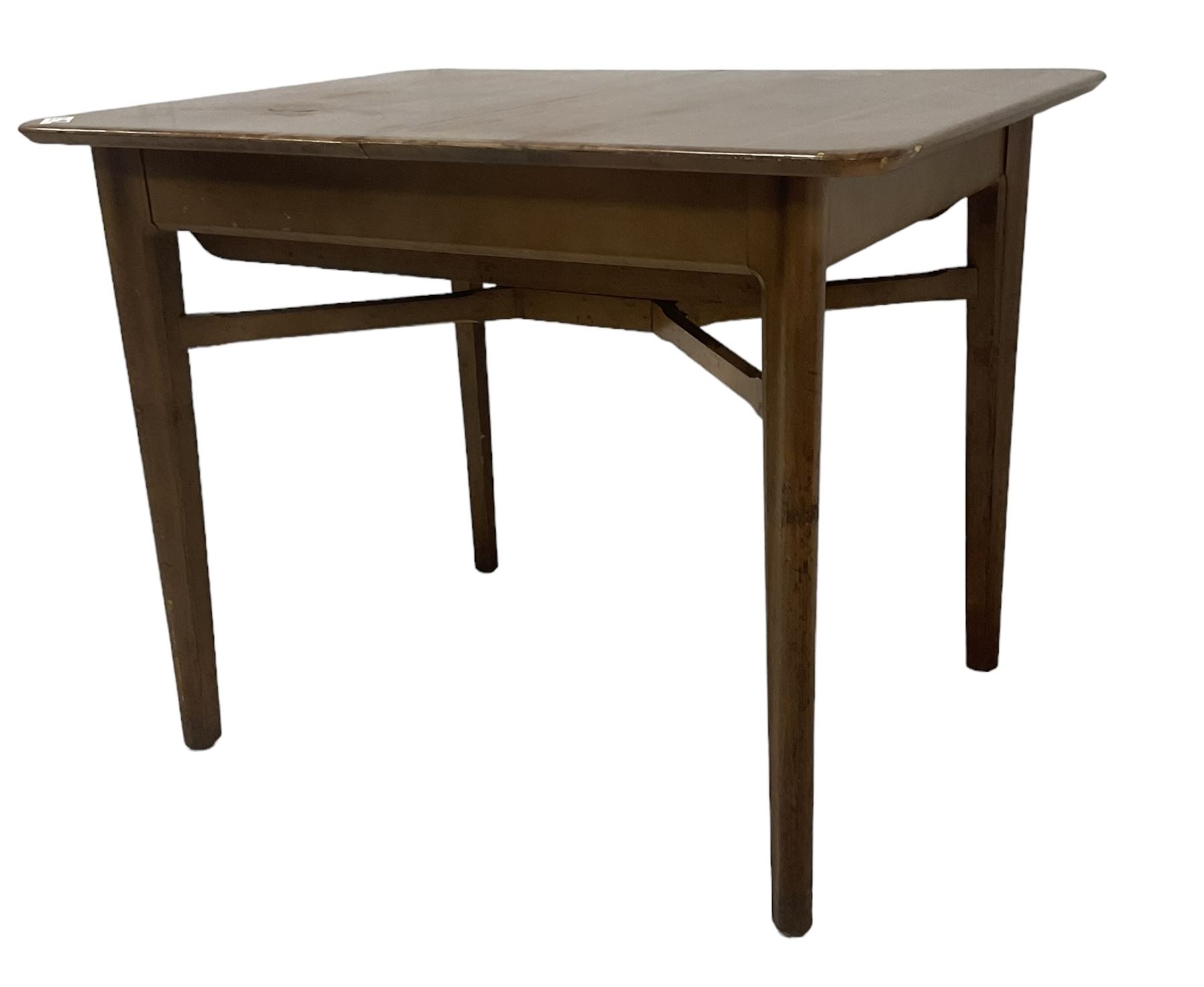 Mid-20th century teak extending dining table, rectangular top with rounded corners, raised on shaped tapering supports united by X-stretcher, with additional leaf