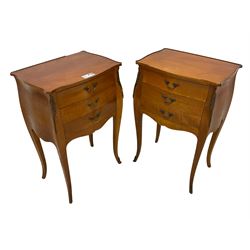 Pair of late 20th century French design cherry wood bedside lamp tables, shaped bombe form, fitted with three drawers, on tapering cabriole supports, decorated with ornate cast gilt metal mounts 