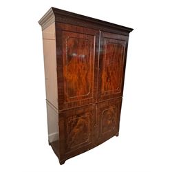 Victorian mahogany linen press, projecting cornice with dentil and scroll detailing, double panelled doors opening to an interior fitted with a brass hanging rail and coat hooks, lower section with two drawers and fitted shelves for additional storage, raised on bracket feet