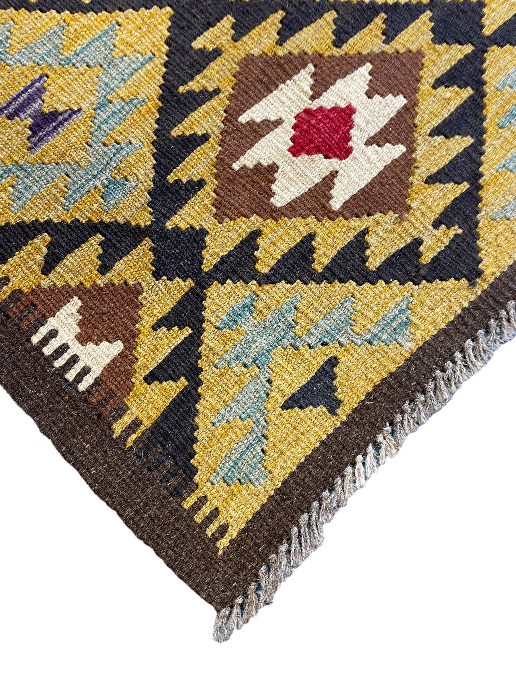 Chobi Kilim multi-colour runner rug, the field decorated with geometric lozenges in contrasting shades on brown ground