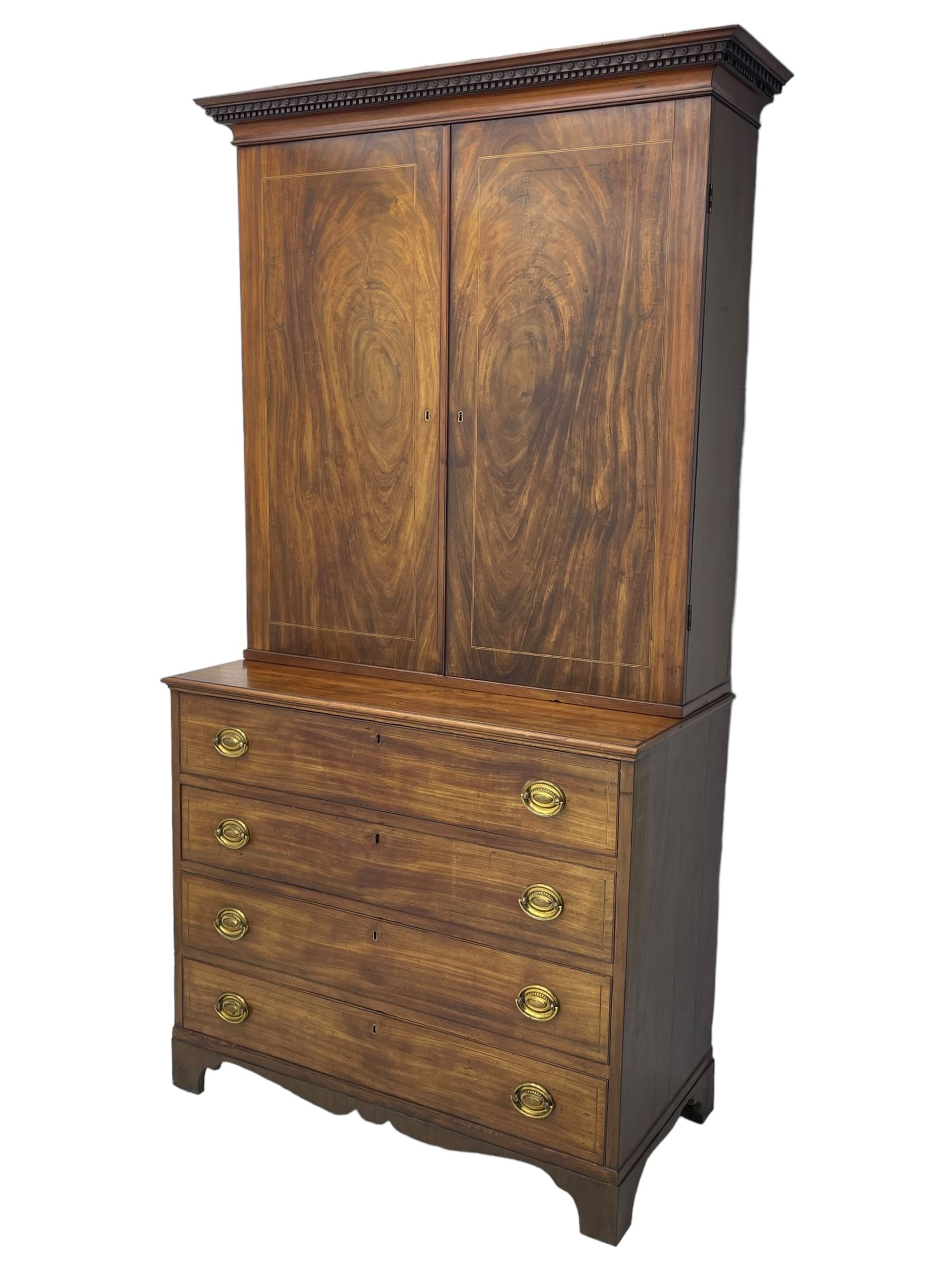 George III figured mahogany secretaire bookcase, projecting moulded dentil cornice decorated with single row of roundels, two figured mahogany doors with boxwood and ebony stringing enclosing three adjustable shelves and three drawers, moulded rectangular top over four long scratch-moulded drawers, the top secretaire drawer with fall front enclosing small drawers, pigeon holes and inset writing surface, shaped apron with bracket feet