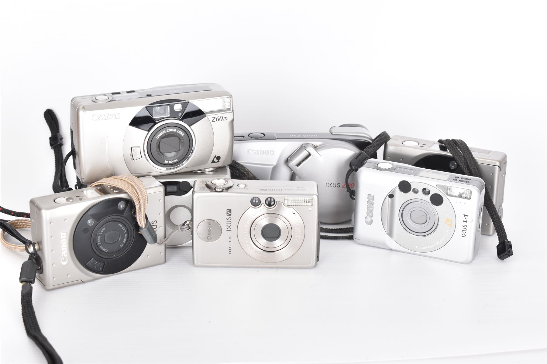 Eight Canon compact Ixus cameras, to include two Ixus examples serial nos. 2309147 & 2273184, Ixus M-1 serial no. 2932566, Ixus L-1 serial no. 2161988, Ixus Z90 serial no. 2201833,  Ixus X-1 serial no. 4704380, Z60IX serial no. 7474817, Ixus V2 serial no. 4431003237 and a Canon Powershot 350 digital camera serial no. H7MX00941