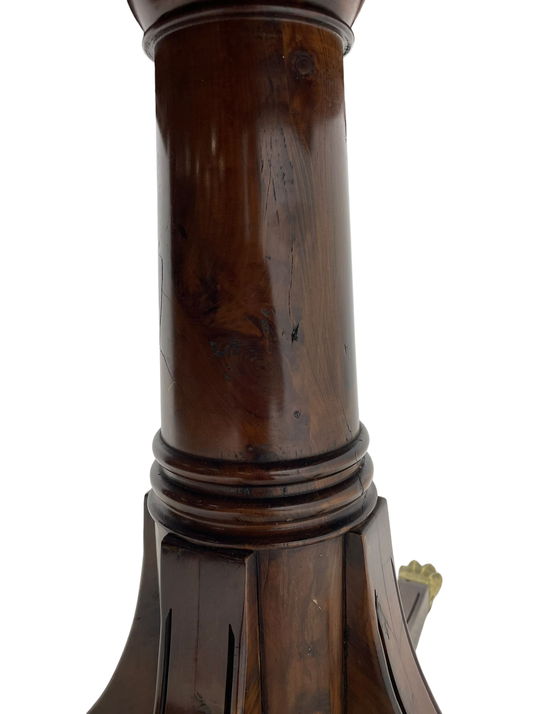 Georgian design inlaid chestnut wood centre table, the circular tilt-top inlaid with satinwood banding, gun barrel turned pedestal on four out-splayed supports, cast brass hairy paw castors, stamped 'P.H.R & Co. Holt, England' 