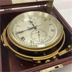 Two-day marine chronometer, with silvered dial inscribed Thomas Mercer Ltd, St Albans, contained within a brass gimbal-mounted bowl and glazed mahogany case, with applied brass plaque reading 'supplied by Kelvin Hughes no. 24295', brass winding key and two service notes to interior of case, dial D12cm, wooden case H17.5cm 