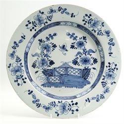 18th century English Delft charger, decorated in underglaze blue with a fence and peony, w...