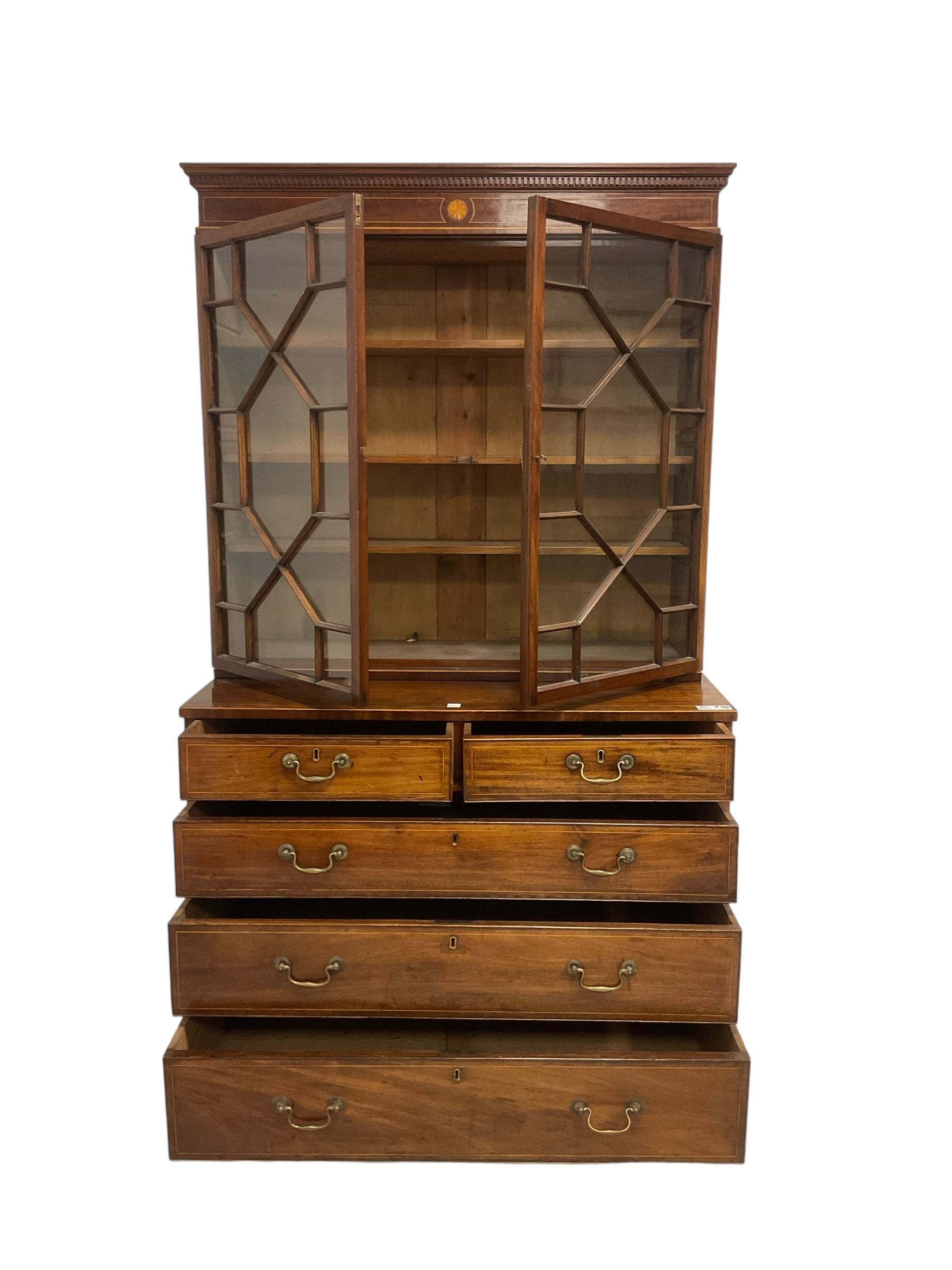 George III mahogany chest of drawers surmounted by a later bookcase, dentil cornice over inlaid frieze and astragal glazed doors, the chest fitted with two short over three long cock-beaded drawers, on bracket feet