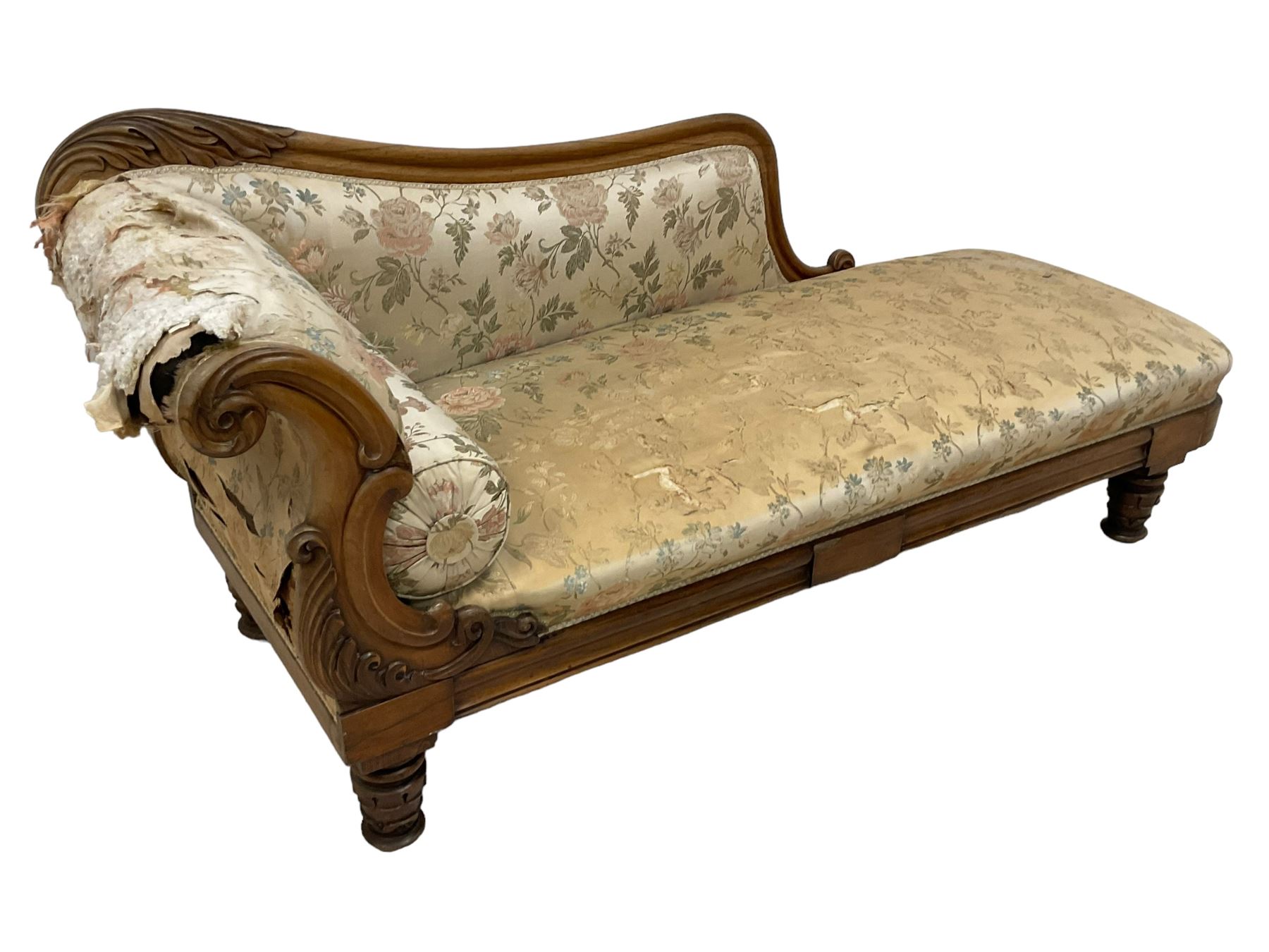 Victorian rosewood chaise longue, rolled back rest and shaped cresting rail carved with curled leaves and scrolls, upholstered in floral pattern fabric with bolster cushion, moulded lower rail with rectangular panel, on turned and lappet carved feet