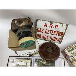 Postcards including WW1 silk postcards, local interest and photographic postcards, gas mask in box, material tape measure and metal sign. 
