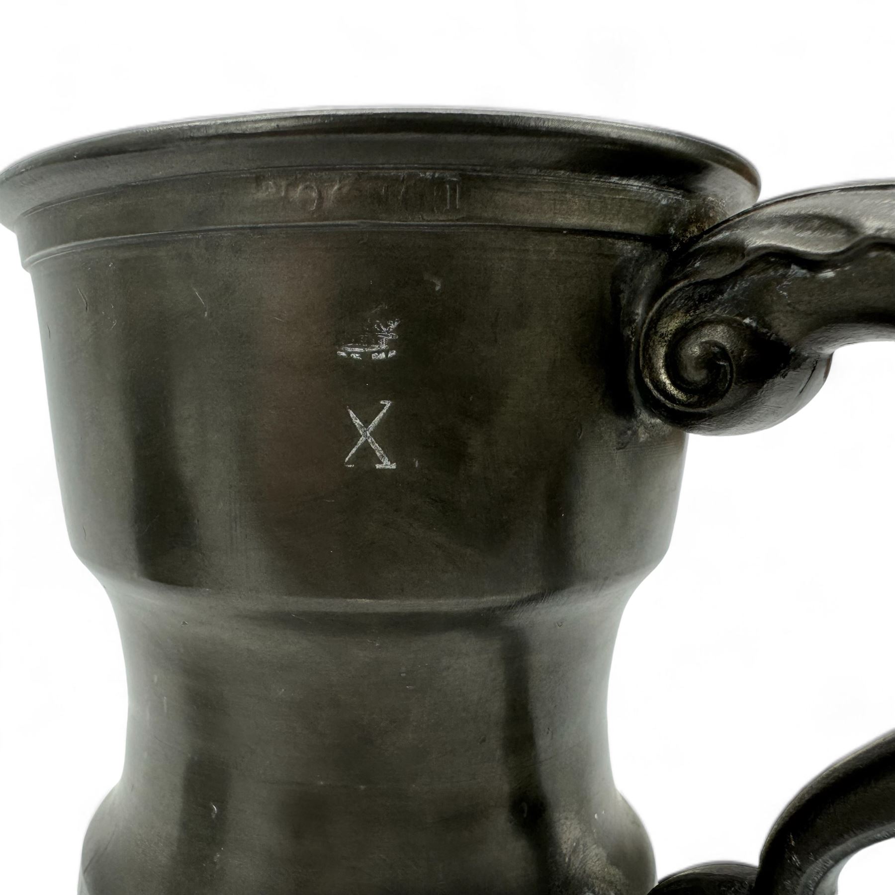 18th century pewter tankard, circa 1770, with scroll handle and acanthus leaf thumbpiece, touch marks and crowned X, H13cm, together with a Victorian 1/2 pint pewter measure, touch marks, weights and measures inspector verification mark (2)