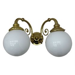 Two brass double-arm wall mounted lights, each with frosted glass globes and scrolled arms (W50cm, D26cm, H31cm); matching central double-arm light with candle-style fittings (W42cm, D24cm, H22cm)