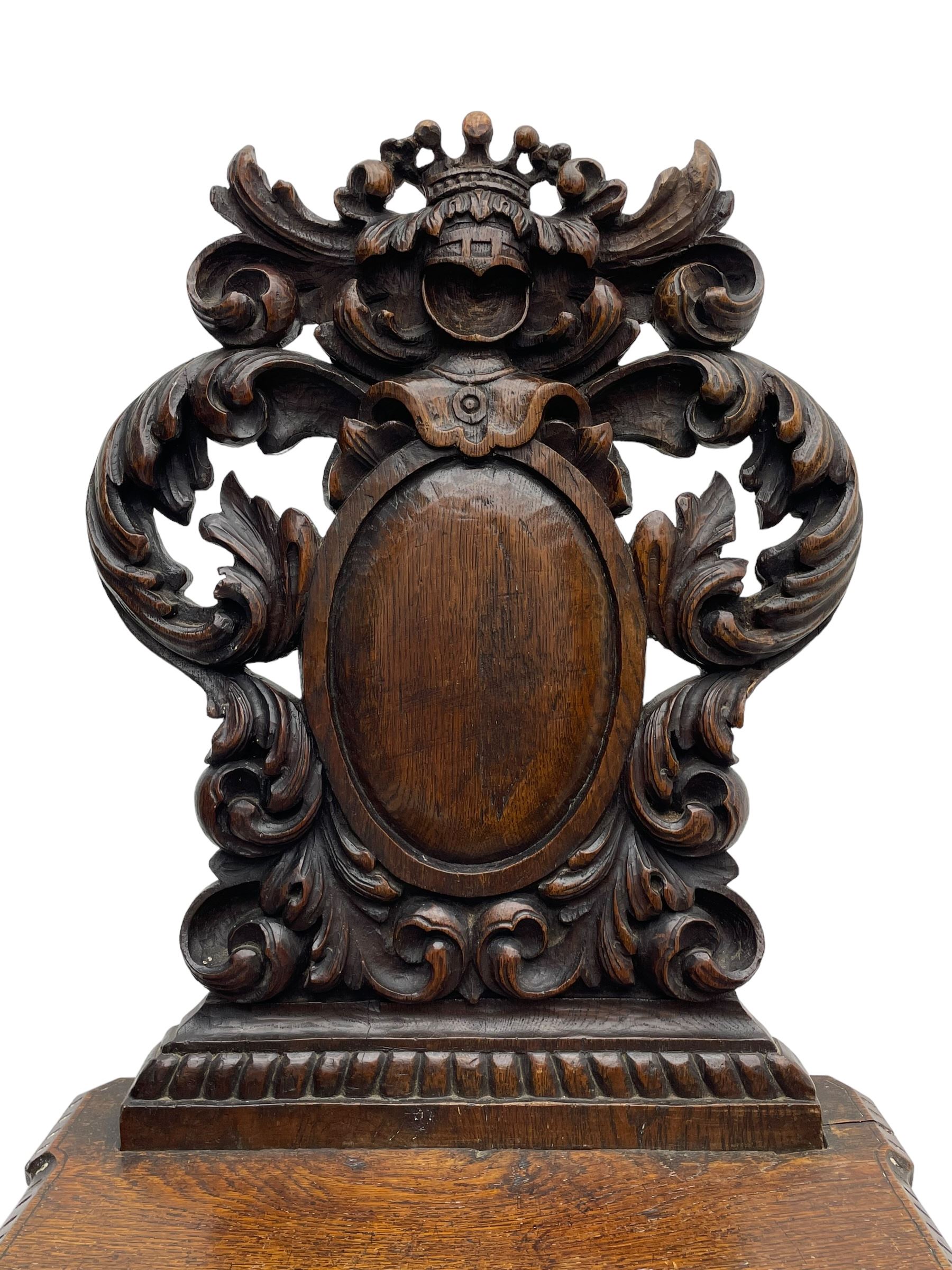 19th century oak hall chair, shaped and pierced back carved with crown cresting over curled and scrolled acanthus leaves, tapered rectangular seat with foliate carved corners and fluted chamfered edge, on turned and lobe carved splayed supports 