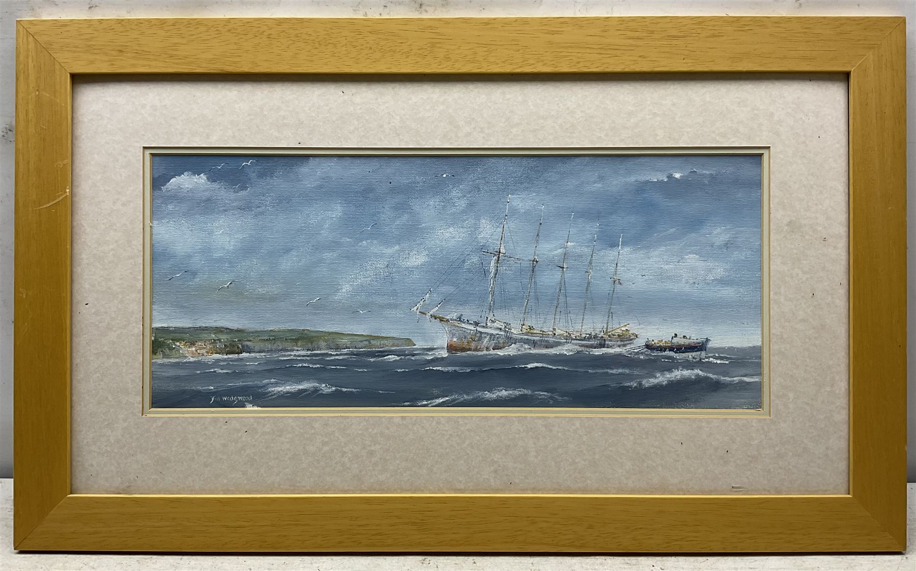 William 'Bill' Wedgwood (British c1934-2019): Lifeboat off Robin Hood's Bay, oil on canvas board signed 19cm x 45cm