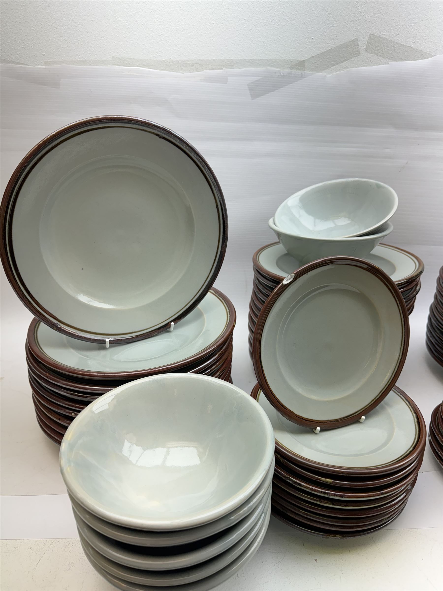 20th century celadon dinner service with iron rim, comprising nineteen dinner plates 26.5cm, twenty-four side plates D24cm, twelve varying bowls, twenty-two tea plates and fifteen saucers 