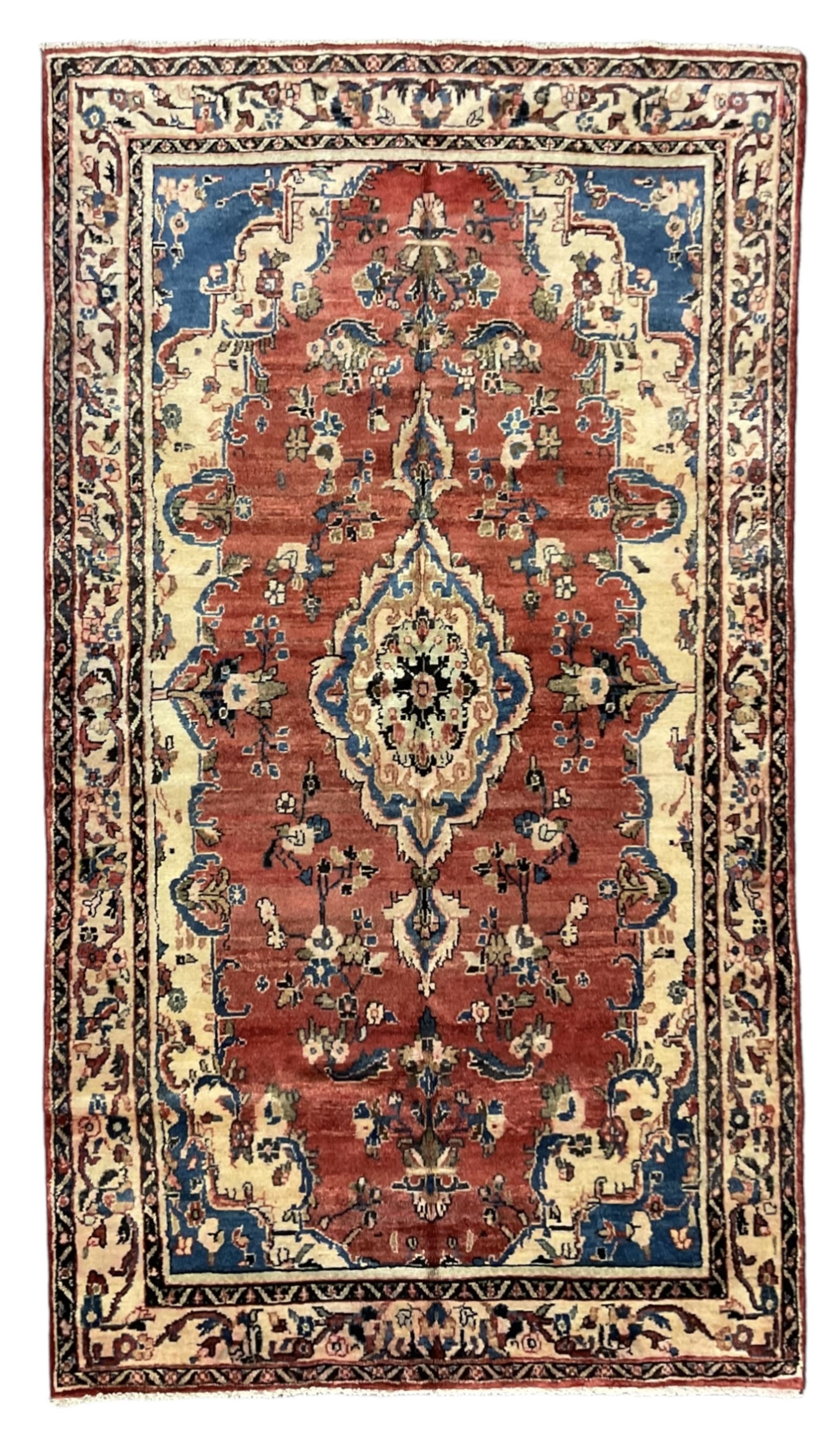 Persian Mahal red ground rug, central floral design pole medallion on a field decorated with flowerheads and foliage, the border decorated with trailing leafy branch and flowerheads 