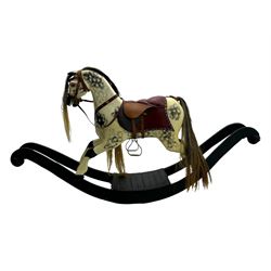 Mid-to-late 20th century carved wooden rocking horse, in dapple grey finish with leather saddle and bridle, mounted on a black painted rocking frame with shaped ends