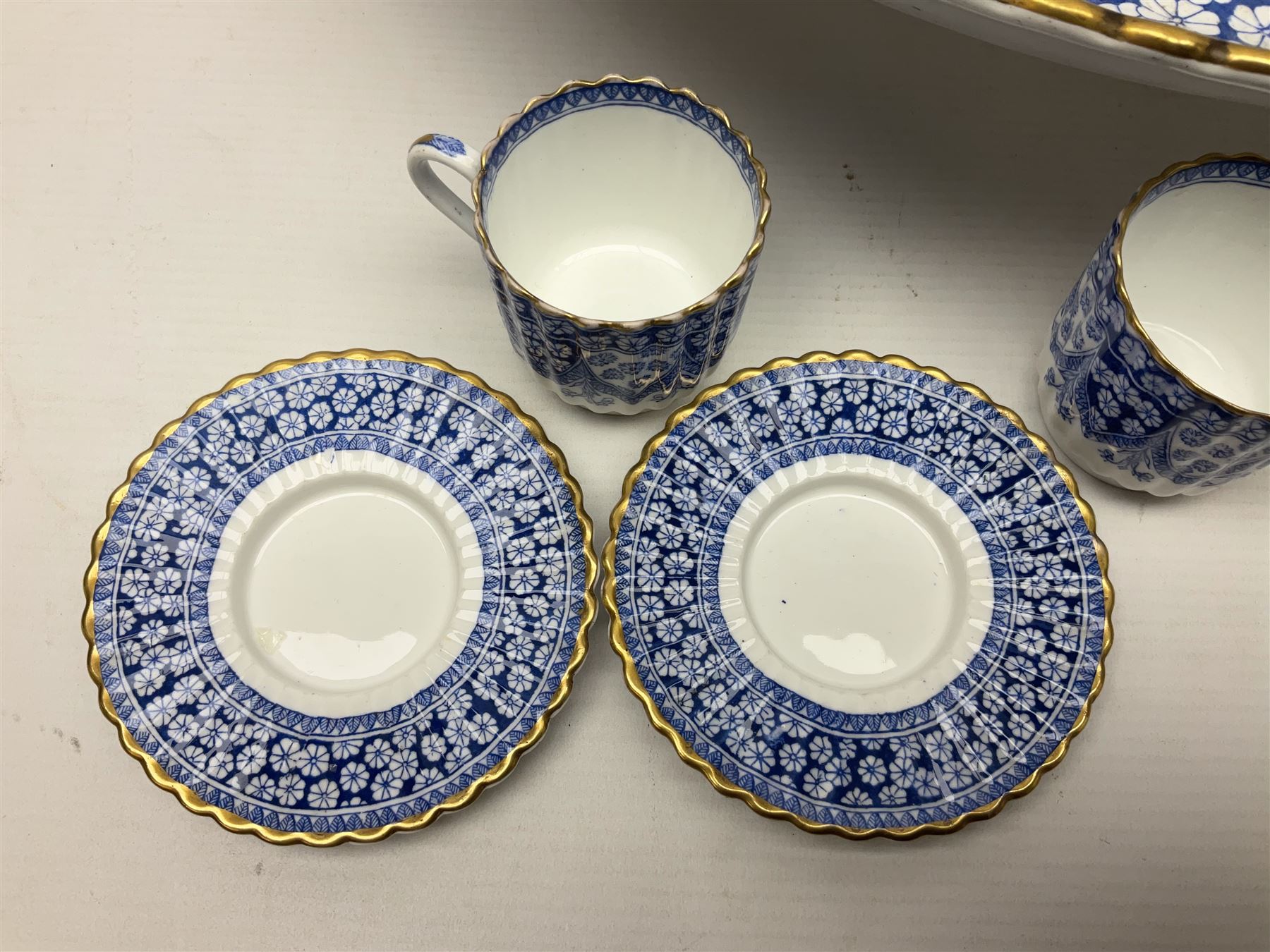 Late Victorian W T Copeland & Sons Primrose pattern coffee set for six, pattern no 2724, comprising coffee pot, milk jug, sugar bowl and six coffee cans and saucers, all upon a Lazy Susan, of circular form, with gilded rim and upon domed pedestal foot, with printed mark beneath, D44.5cm