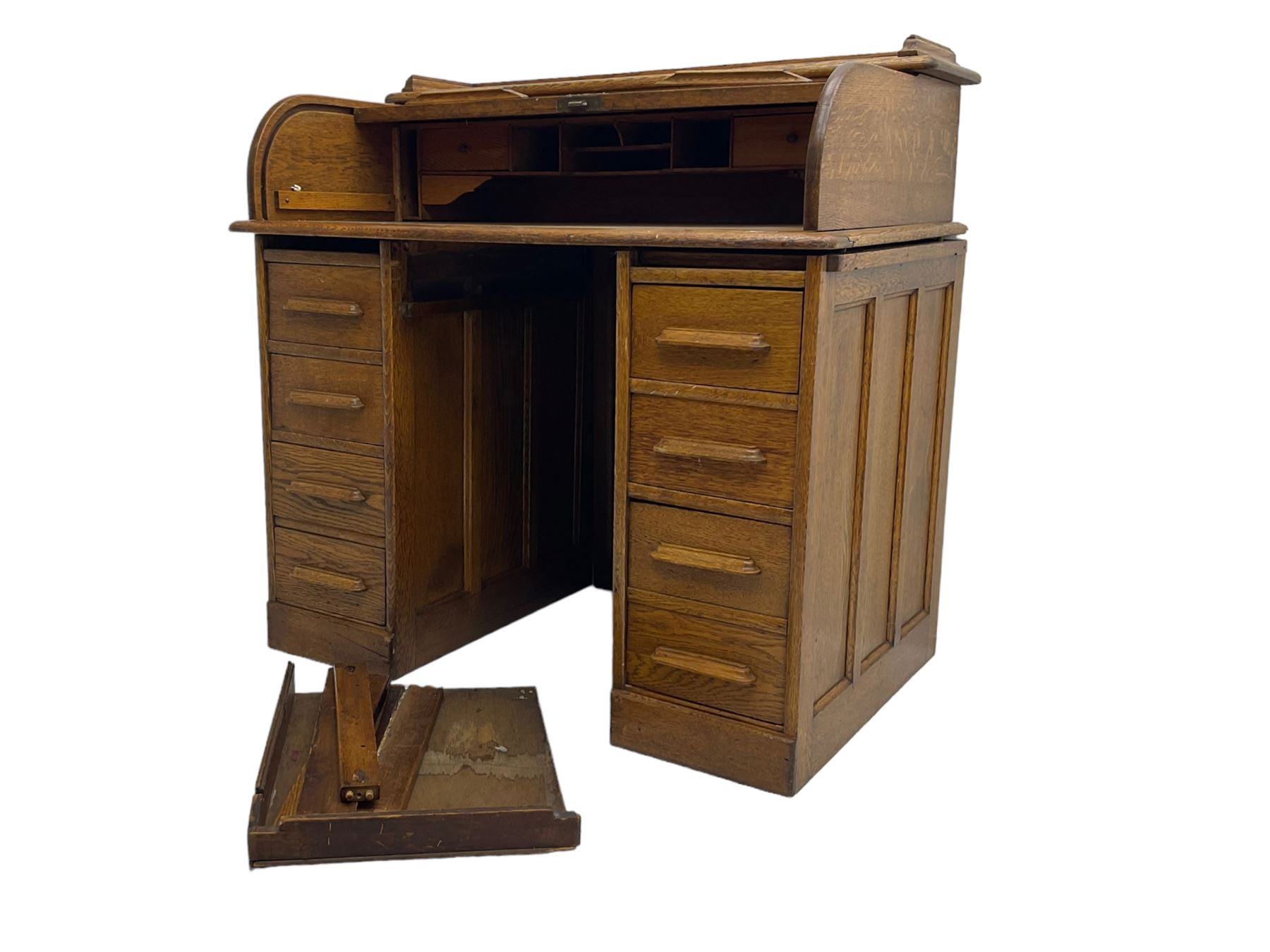 Early 20th century oak twin pedestal desk, tambour roll top enclosing fitted interior, eight drawers, on plinth base