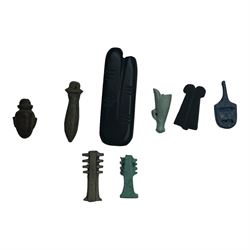 Eight Egyptian amulets, comprising black stone two figure amulet modelled as an outstretched index and middle finger, two faience Djed pillar amulets, obsidian double plume amulet, faience white crown amulet, papyrus amulet, heart amulet, and another blue example, largest two figure amulet L5.5cm