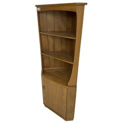 Ercol - mid-20th century '743C'  light elm corner cabinet, fitted with two open shelves over a single cupboard