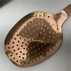 Large 19th century copper slotted spoon, with pierced flat bowl, L55cm, together with two 19th century iron handled ladles with circular copper bowls, largest example L48.5cm, (3)