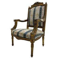 Late 20th century French design carved giltwood armchair, the cresting rail carved with scrolled foliage over foliate carved platform, upholstered in striped fabric decorated with trailing foliage and flower heads, acanthus carved arm terminals and upright supports, on turned and fluted supports 