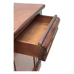 Mid 19th century mahogany sideboard, rectangular top over two frieze drawers with rounded edges, flanked by floral carved corbels, over two panelled cupboard doors, raised on a plinth base