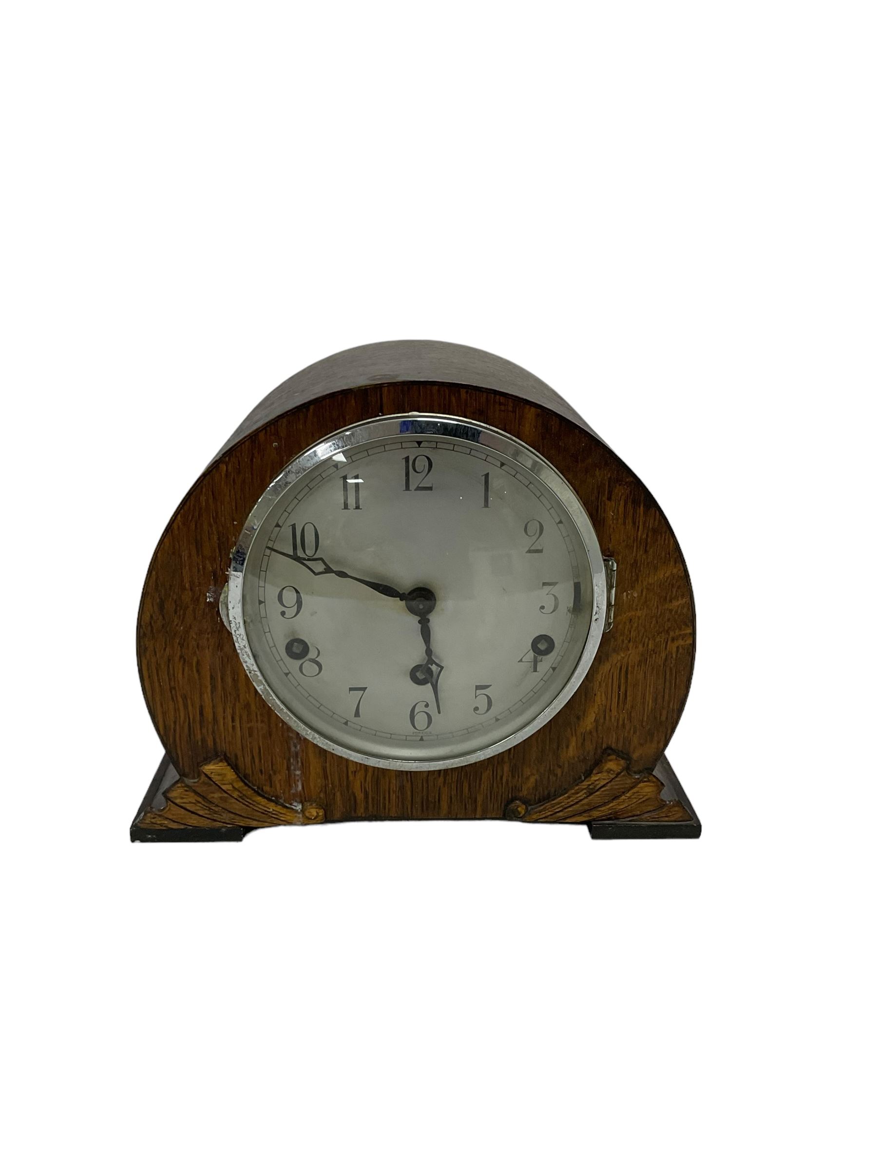 Assortment of three mantle clocks and an aneroid barometer.