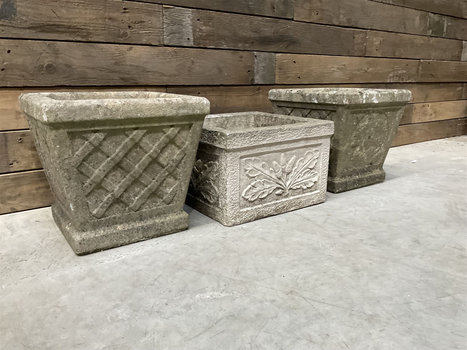 Pair of square cast stone planters, single planter with leaf decoration and a rectangular brick effect planter (4)