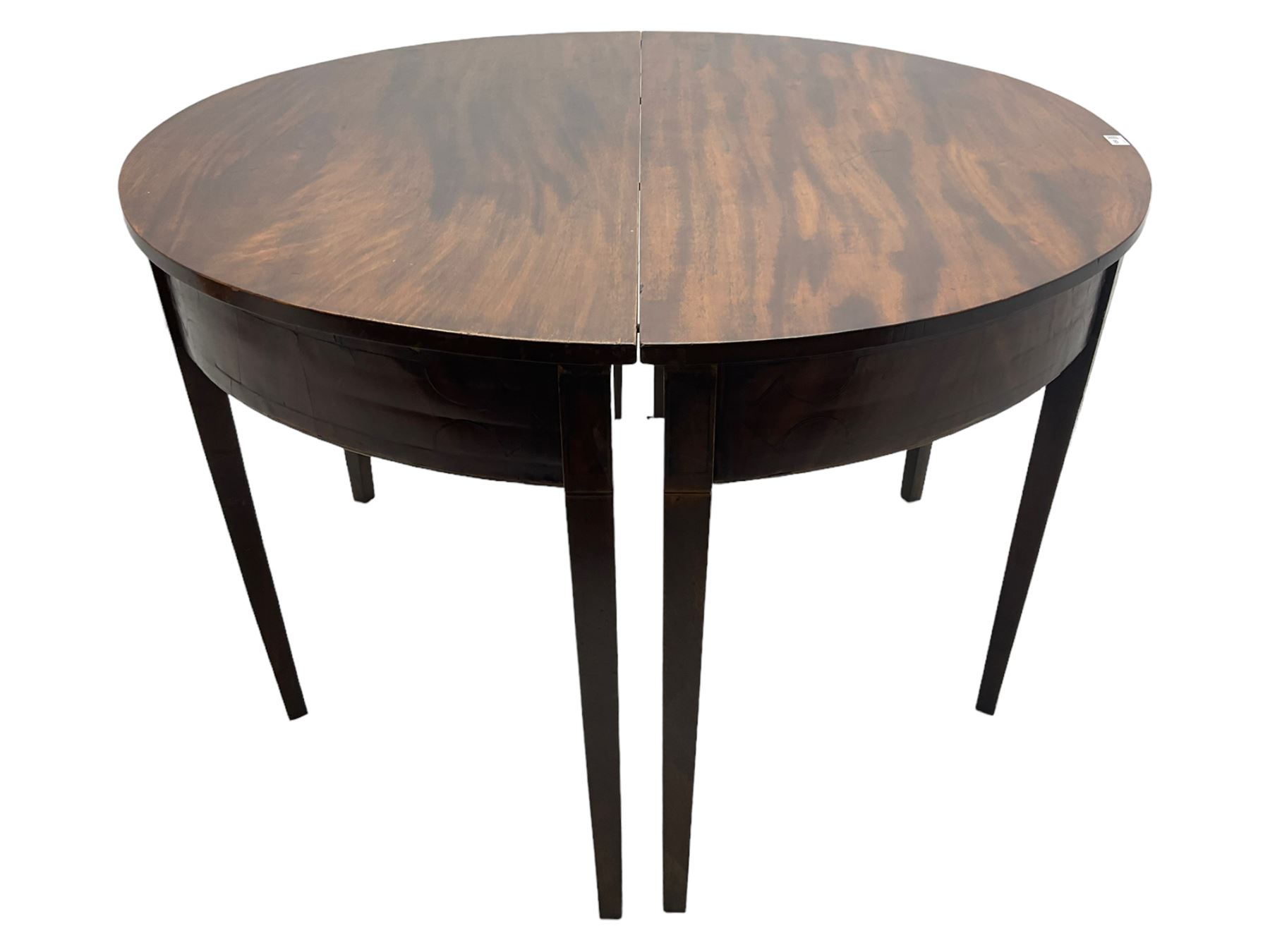 Regency mahogany D-ended extending dining table, circular top with banded fireze inlaid with ebony stringing, raised on square tapering supports, with two additional leaves, supported by gate-leg central action